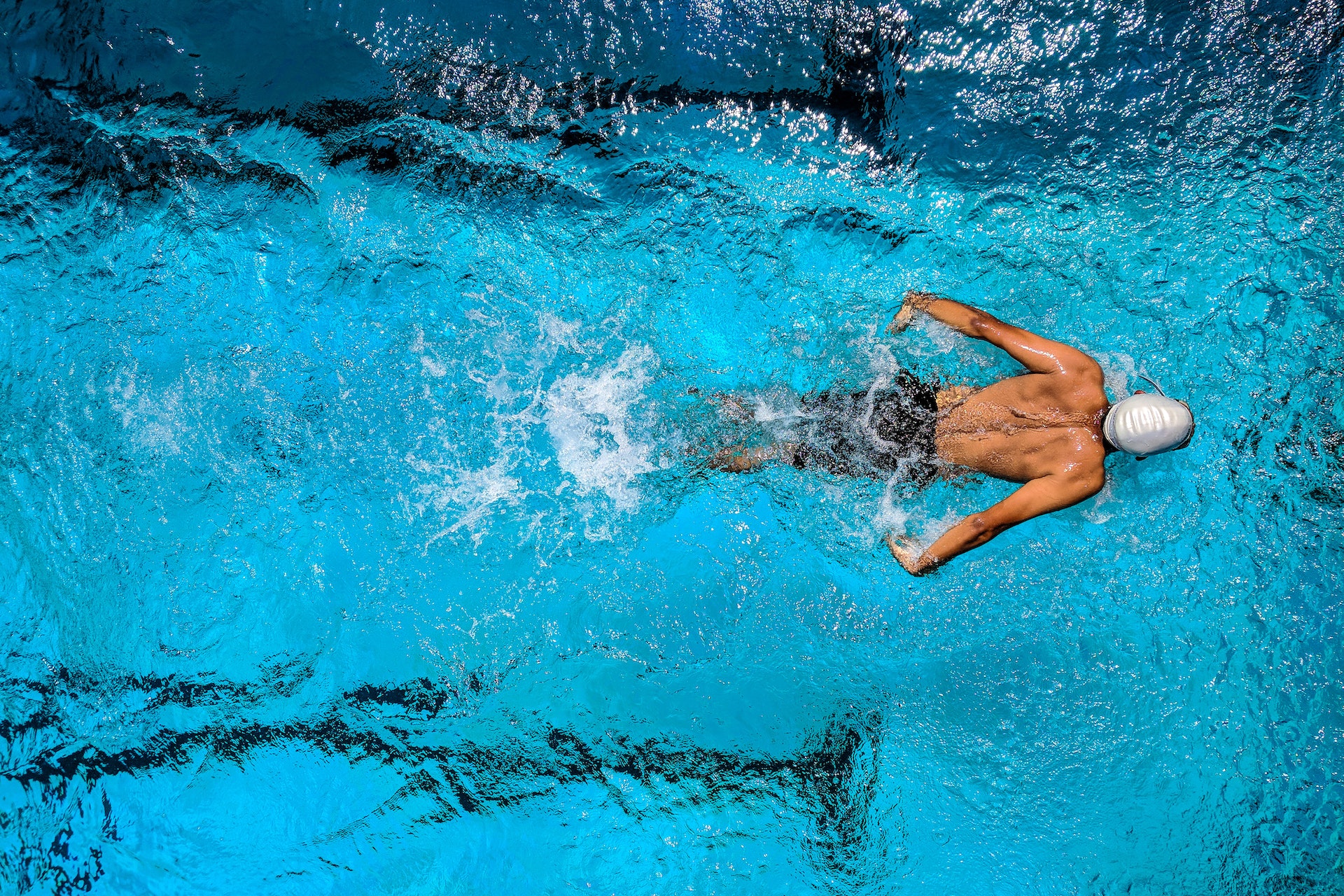 Aerial photography of a man swimming in a pool